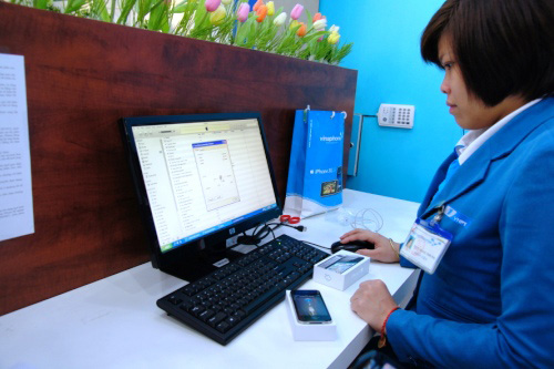 Nhân viên VinaPhone kích hoạt máy cho khách hàng.