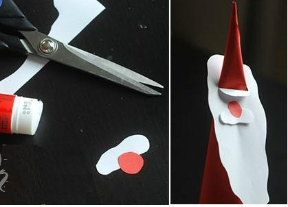 Cut a small circle of red paper for the nose and a small white cloud to make Santa's mustache.