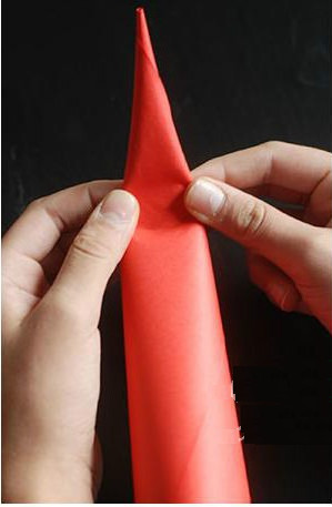 Slightly fold the pointed end of the cone to create Santa's hat