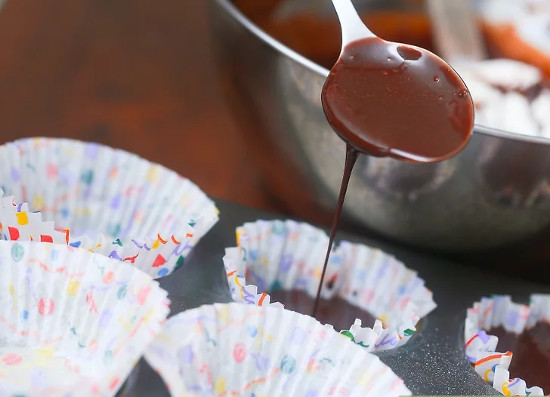 Xúc mẻ bột vào khuôn muffin đã chuẩn bị