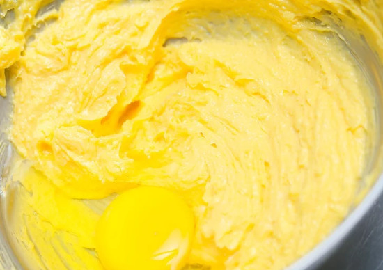 Cho từng lượng nhỏ trứng vào và trộn đều mỗi lần thêm trứng