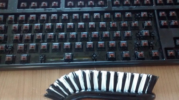 Dùng bàn chải để vệ sinh bàn phím 