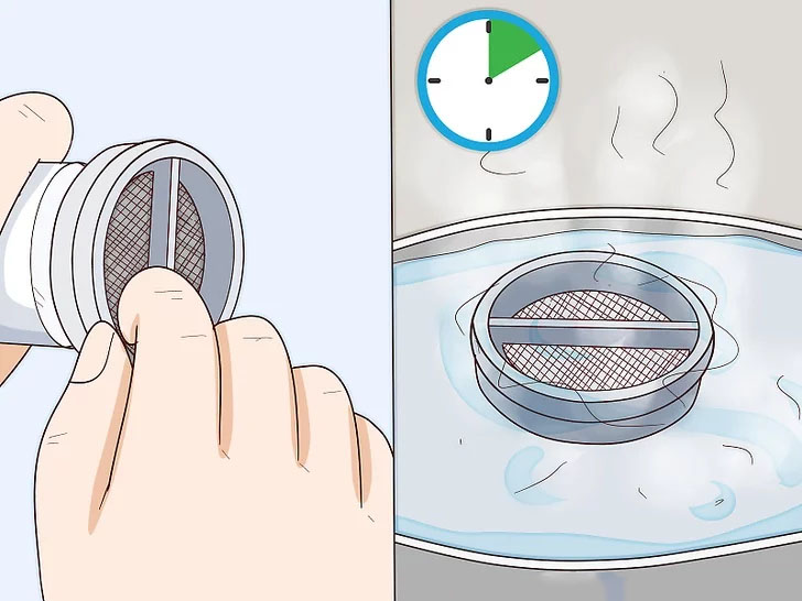 Tháo tấm lọc ra, vệ sinh sạch sẽ và ngâm trong nước ấm 10 phút