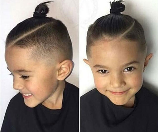 The man bun hairstyle brings a strong masculine look to the boy. 