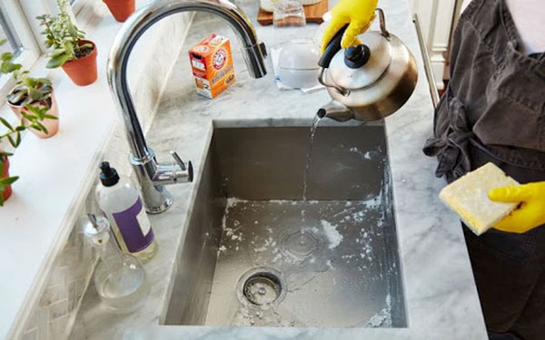 Salt, vinegar, and hot water help eliminate odors in the sink