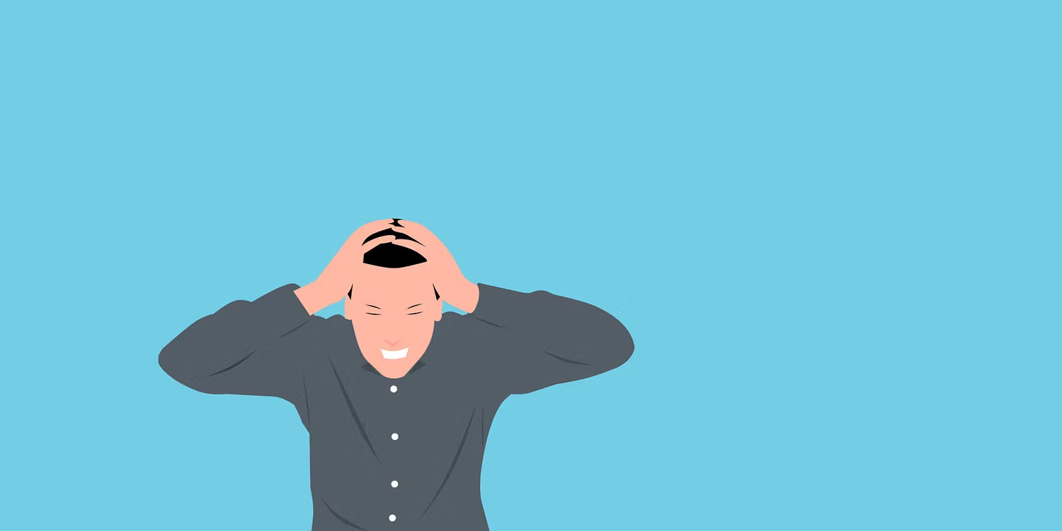 Một người đàn ông căng thẳng ôm đầu