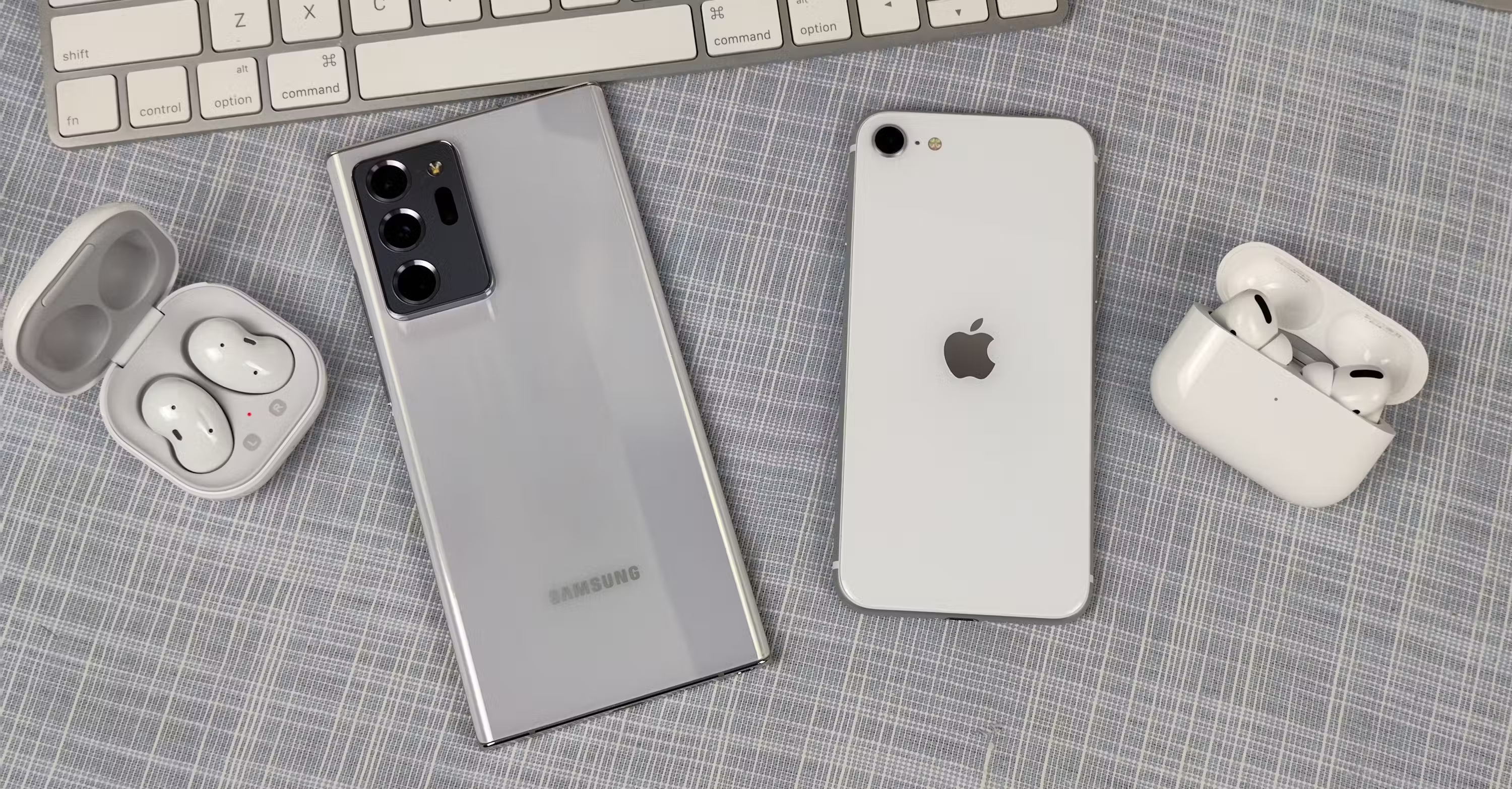 Điện thoại iPhone và Samsung Galaxy với Galaxy Buds và AirPods Pro bên cạnh