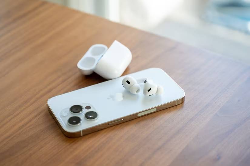 Apple AirPods Pro thế hệ 2 được đặt trên mặt sau của iPhone 14 Pro